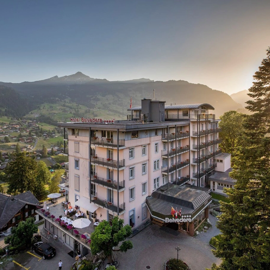 2 people on a balcony with a view of the mountains